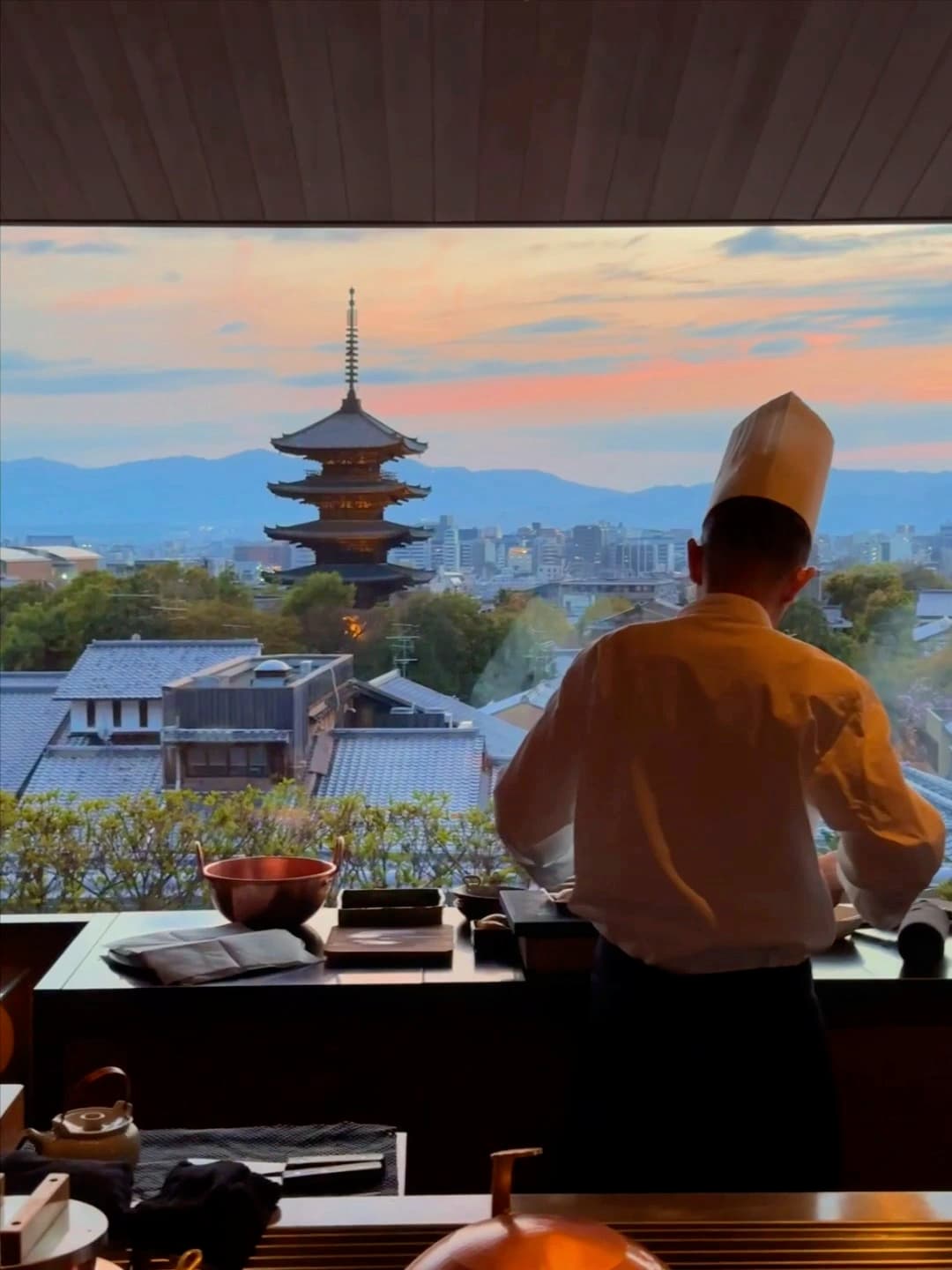 Friendly and skilled bartender at Bar KOHAKU in Park Hyatt Kyoto, crafting unique cocktails