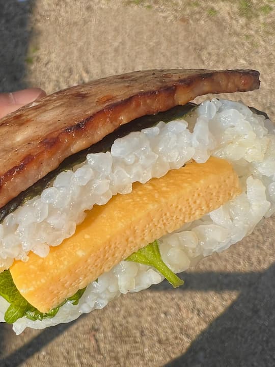 Spam onigiri with thick slices of grilled ham, tamagoyaki, and perilla leaves at KYOTO ONIMARU, an onigiri (rice ball) shop in Kyoto