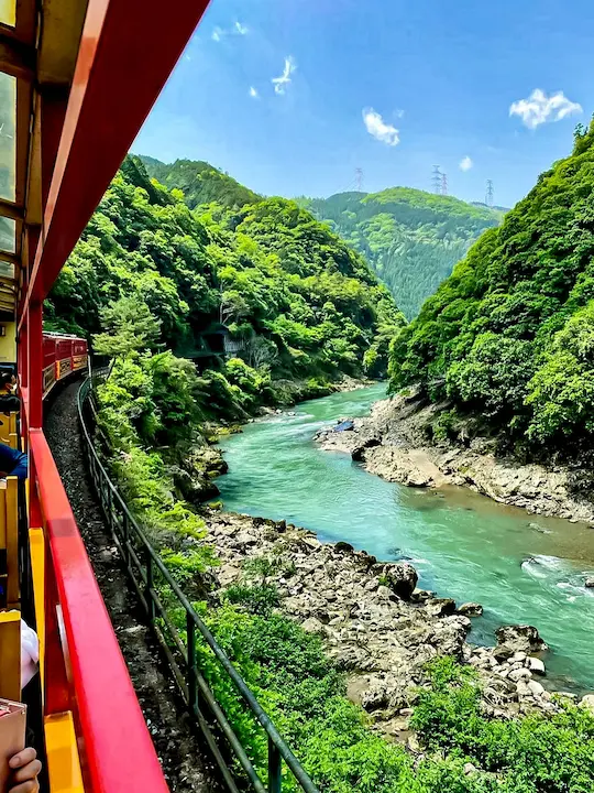Stunning view of the gorge from the open-air observation car on the Sagano Scenic Railway in Kyoto's Arashiyama