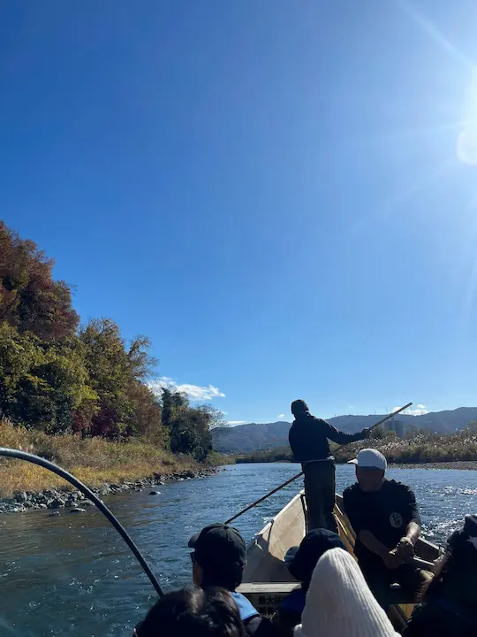 Hozugawa River boat ride in Kyoto's Arashiyama, showcasing a traditional boat navigating the serene river